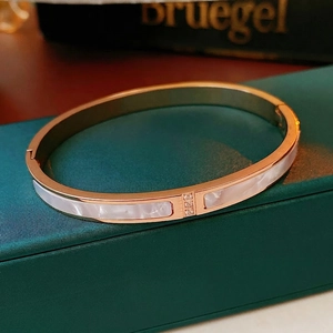 Rose gold titanium steel bangle with white shell inlay and three centered diamonds