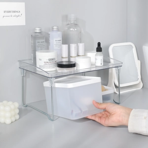 Modern transparent acrylic tiered desk organizer with white storage bins and metal legs