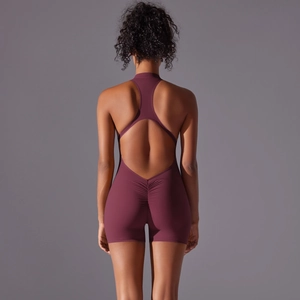 Detail of scrunch butt seam and open back design on a dark red yoga bodysuit