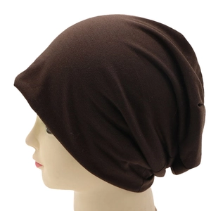 Side view of dark brown knitted slouchy beanie on mannequin showing fabric texture