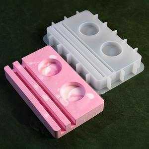 Macro view of silicone mold and pink marble resin base with double slots and candle holes