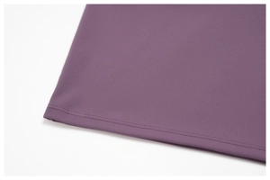 Macro shot of purple yoga set showing fine knit fabric texture and double-stitch hem details
