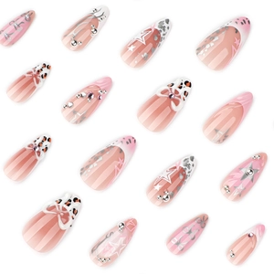 Pink ombre almond press-on nails with 3D bows, rhinestones and silver star accents