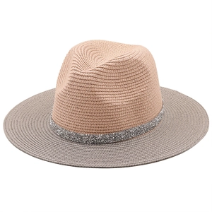 Detail of two-tone woven Panama hat featuring silver sequin band and straw texture