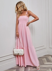 Close-up of pink strapless maxi dress showing ruched chest detail and high-quality fabric