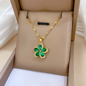 Green crystal flower pendant necklace in a luxury jewelry box with golden chain detail