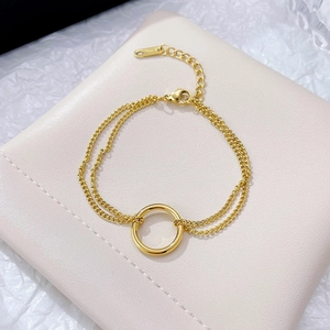 Double-layered golden stainless steel chain bracelet with a minimalist circular ring charm