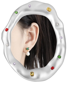 Detail of elegant gold earrings with green emerald-cut stones and drop pearls
