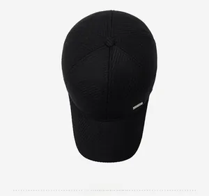 Close-up of black wool baseball cap with vertical texture and metal side logo detail