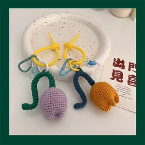 Detail of handmade crochet tulip keychains in purple and orange with colorful carabiners