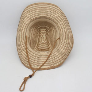 Detail of straw cowboy hat interior with beige sweatband and brown chin strap