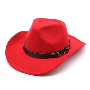 Detail of red wool felt western cowboy hat with black leather band and gold buckle