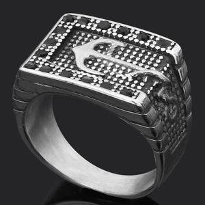Detailed macro view of men's square titanium ring with black stone and embossed anchor