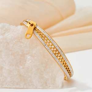 Golden stainless steel zipper bracelet with double row white zircons on a white stone