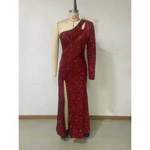 Detail of red sequined dress with long sleeve and sparkling fringe elements