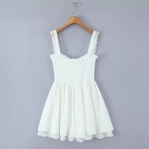 Detailed view of white sleeveless babydoll dress with lace trim on hangers