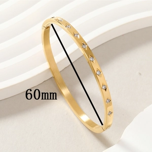 Polished gold titanium steel bangle with 60mm inner diameter and inlaid clear crystals