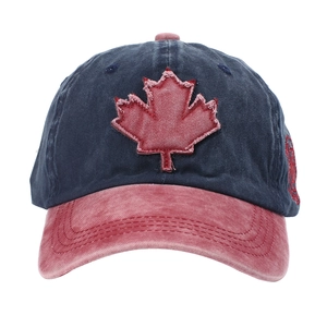 Detail of vintage washed baseball cap featuring a red maple leaf patch and distressed seams