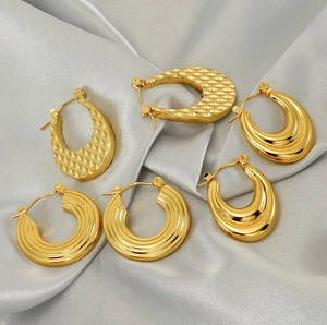 Detailed macro view of 18K gold-plated stainless steel hoop earrings in various textures