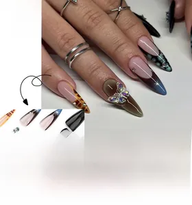 Detail of extra long stiletto press-on nails with bow rhinestones and tortoiseshell design