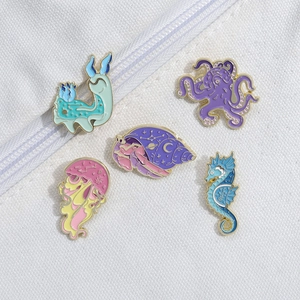 Set of five colorful ocean animal enamel pins with jellyfish octopus and seahorse designs