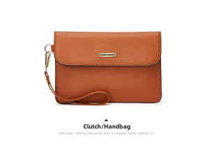 Detailed view of a brown textured wristlet clutch bag with elegant gold metal hardware