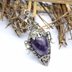 Macro detail of purple gemstone pendant in vintage copper hollow metal crown frame