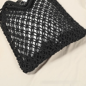 Close-up of black handmade woven hollow mesh bag with detailed cotton cord craftsmanship