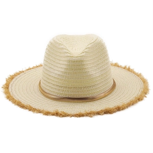 Detail of wide brim raffia sun hat with fringe edge and golden chain decoration