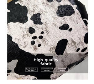 Macro shot of stylish black and white cow print leather texture with lychee grain detail