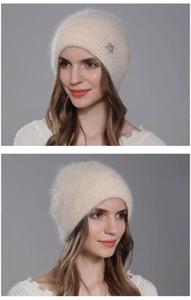Close-up of beige angora knit beanie with sparkling rhinestone star detail and soft texture