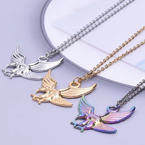 Detail of eagle pendants in silver, gold and rainbow colors on a soft purple background