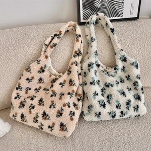 Detail of plush floral tote bags with magnetic closure and retro flower pattern