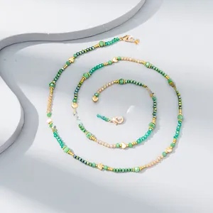 Detail of colorful crystal beaded glasses chain with green beads and gold heart pendants