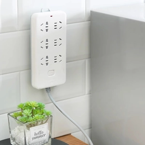 6-outlet power strip with switch and indicator light on a modern wooden desk background