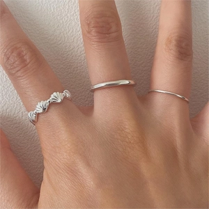 Macro detail of 925 sterling silver ring set featuring shell texture and slim band