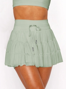 Detail of light green mesh skirt showing layered tulle texture and drawstring waist design