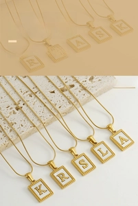 Detail of 18K gold plated rectangle alphabet necklaces with white shell inlay