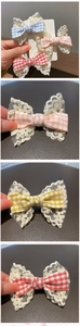 Detailed view of checkered lace bow hair clips for girls in blue, pink and red tones