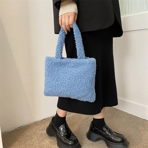 Blue fuzzy teddy plush handbag for women styled with a black blazer and skirt