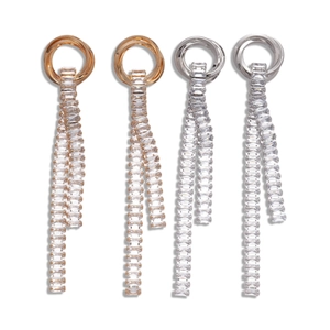 Elegant gold and silver tassel earrings with cubic zirconia stones on white background