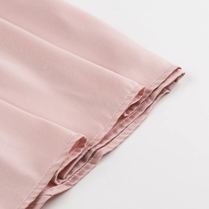 Macro view of pink silky fabric with precise double-stitching and fine texture detail