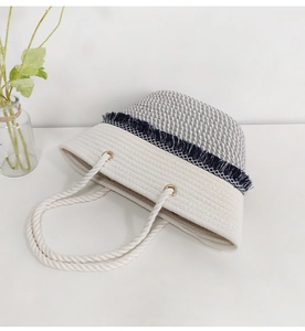 Detail of bohemian woven tote bag with grey contrast, tassel band and cotton rope handles