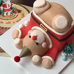 Inverted Santa Claus themed cake topper with red and green hat for Christmas decoration