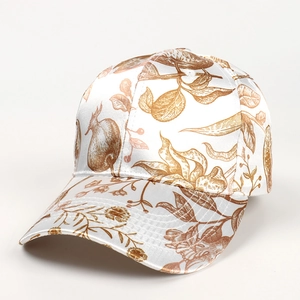Detail of satin baseball cap featuring vintage palm tree and pomegranate floral prints