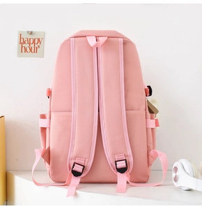 Rear view of pink nylon school backpack with padded straps and side pockets for students