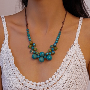 Gros plan du collier bohème avec perles en céramique turquoise et cordon tressé à la main
