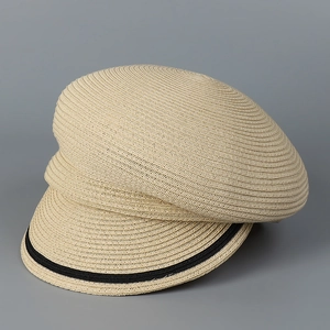 Close-up of beige woven straw hat with contrasting black ribbon band and detailed texture