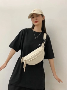 Versatile cream canvas crossbody chest bag with adjustable strap and sleek zipper