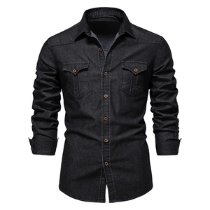 Detail of long sleeve denim shirt showing copper buttons and flap pockets on dark fabric